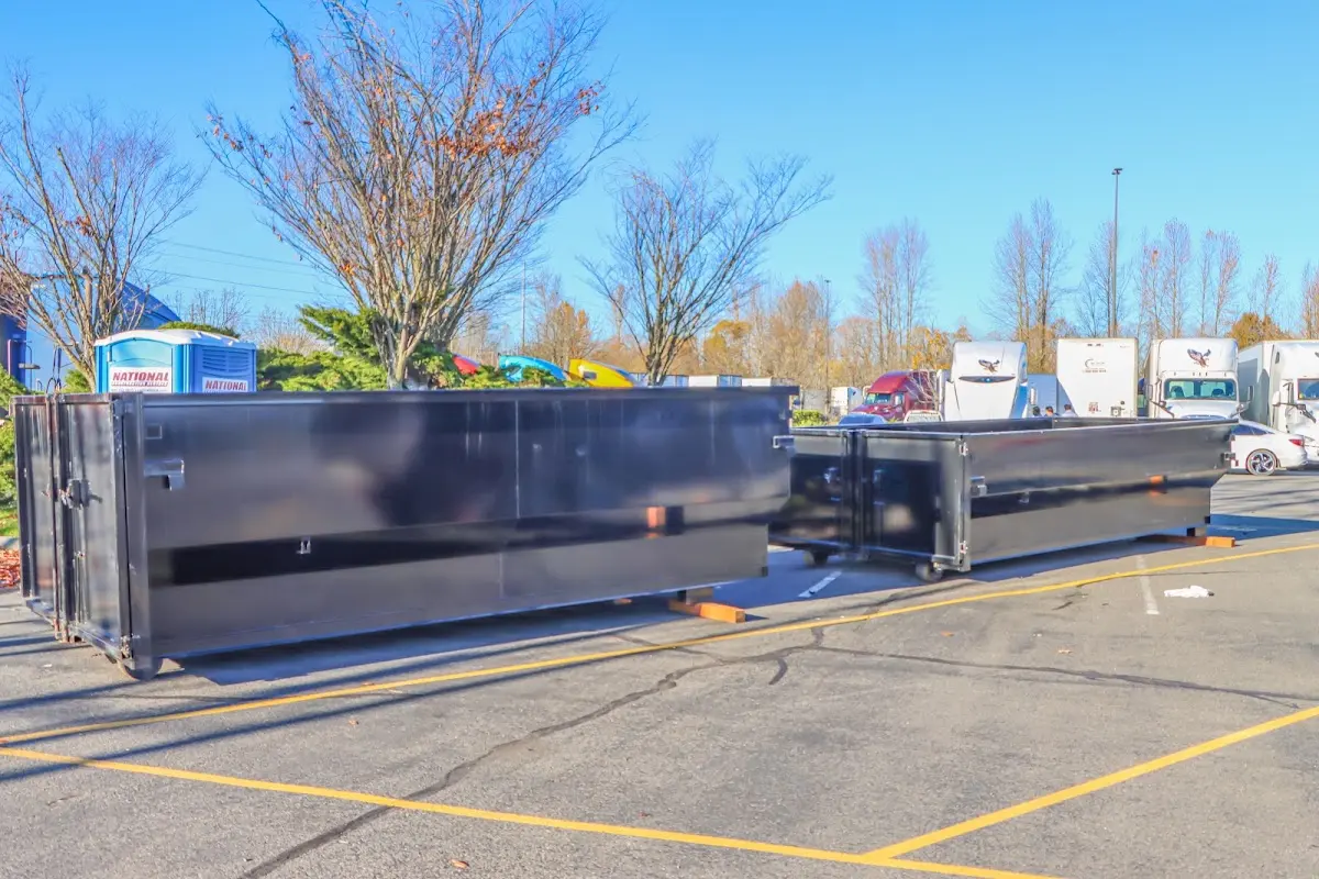 Professional dumpster rental service with roll-off container on residential driveway in Waseca